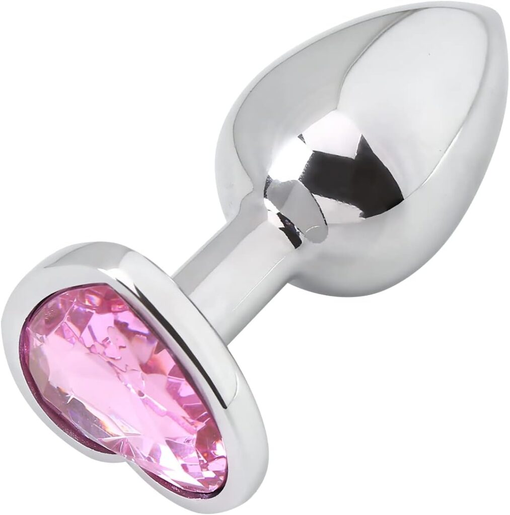 silver butt plug with a pink crystal heart base against a white background