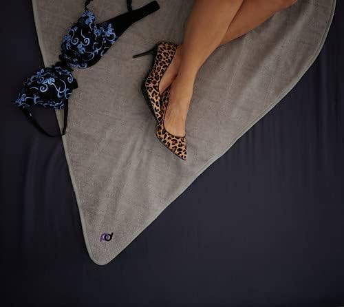 Grey blanket with a bra on it and a woman's legs with leopard print high heels.
