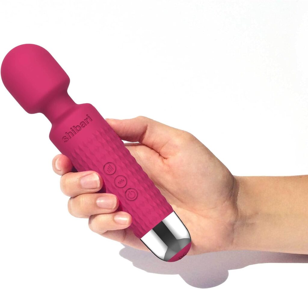 Pink vibrator held in a human hand